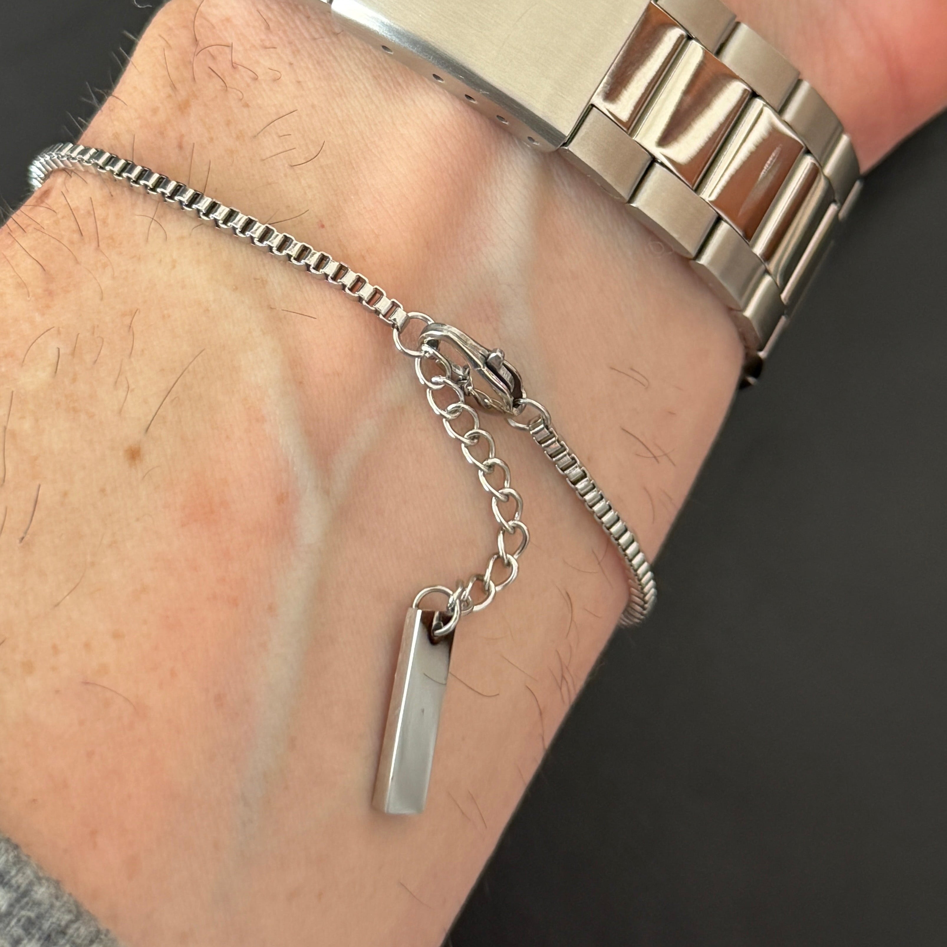 steel bracelet on man's wrist