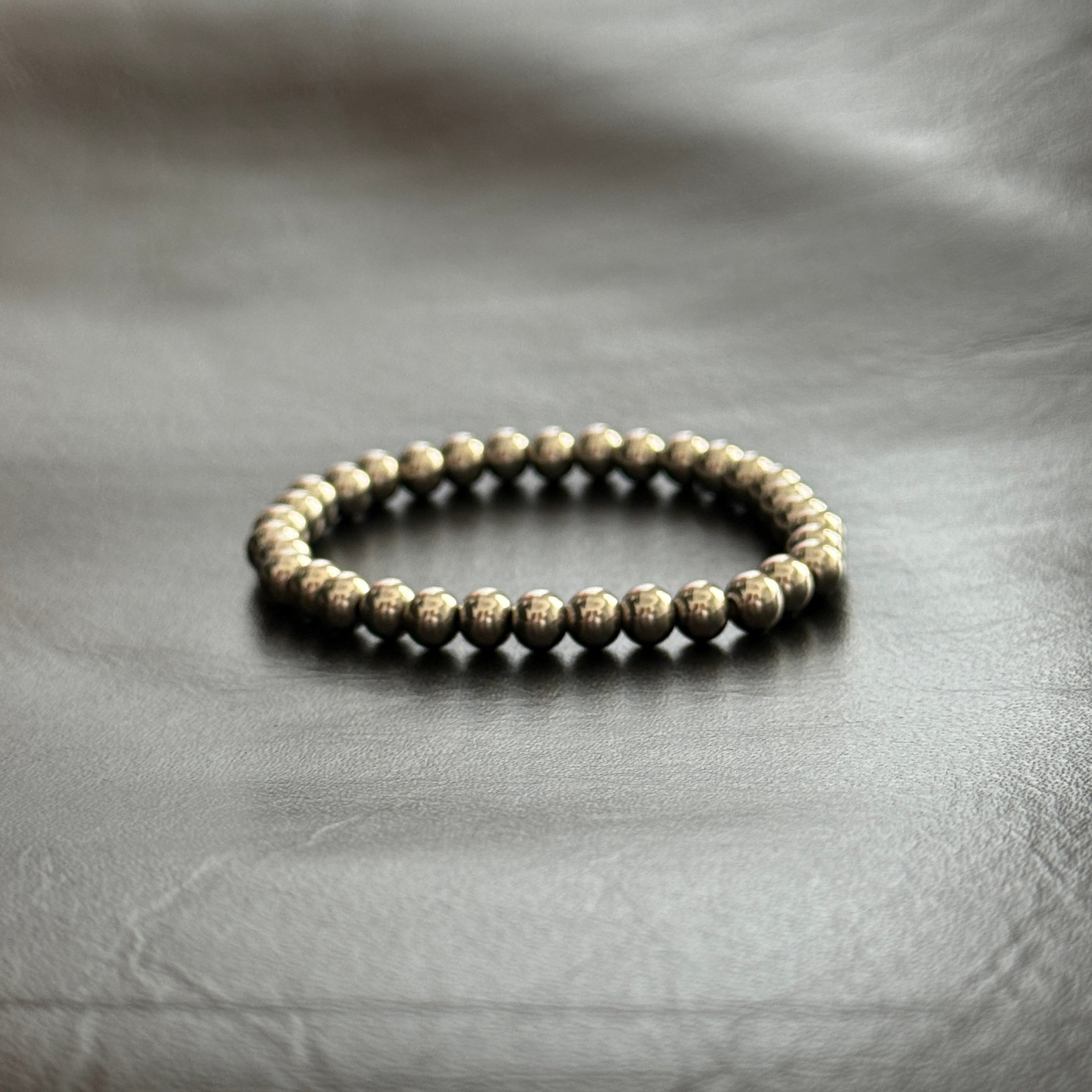 Beaded bracelet on a textured gray surface